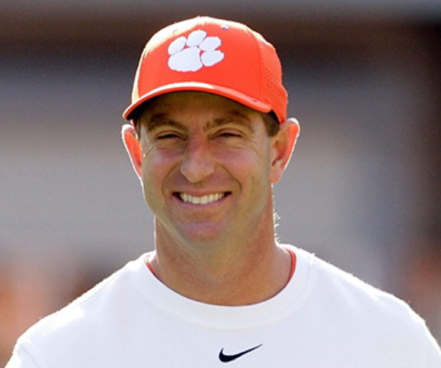 A man wearing orange cap smiling at camera